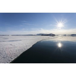 Svalbard Sunburst reflected in still water