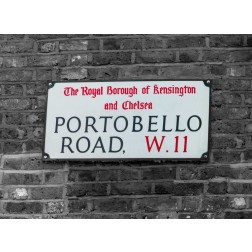 Portobello road sign board on a brick wall, London, UK