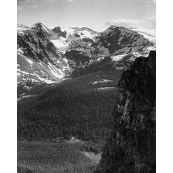 View of snow-capped mountain timbered area below, in Rocky Mountain National Park, Colorado, ca. 194